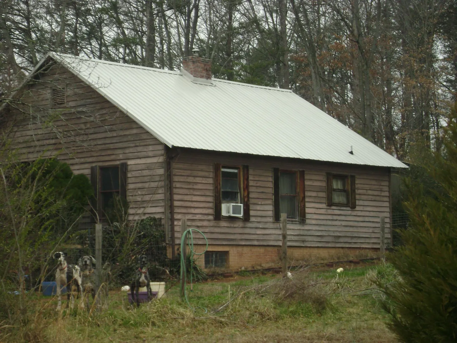 White metal roof on an old wood sided farmhouse, from a Metal Roof Installation job in Westmoreland
